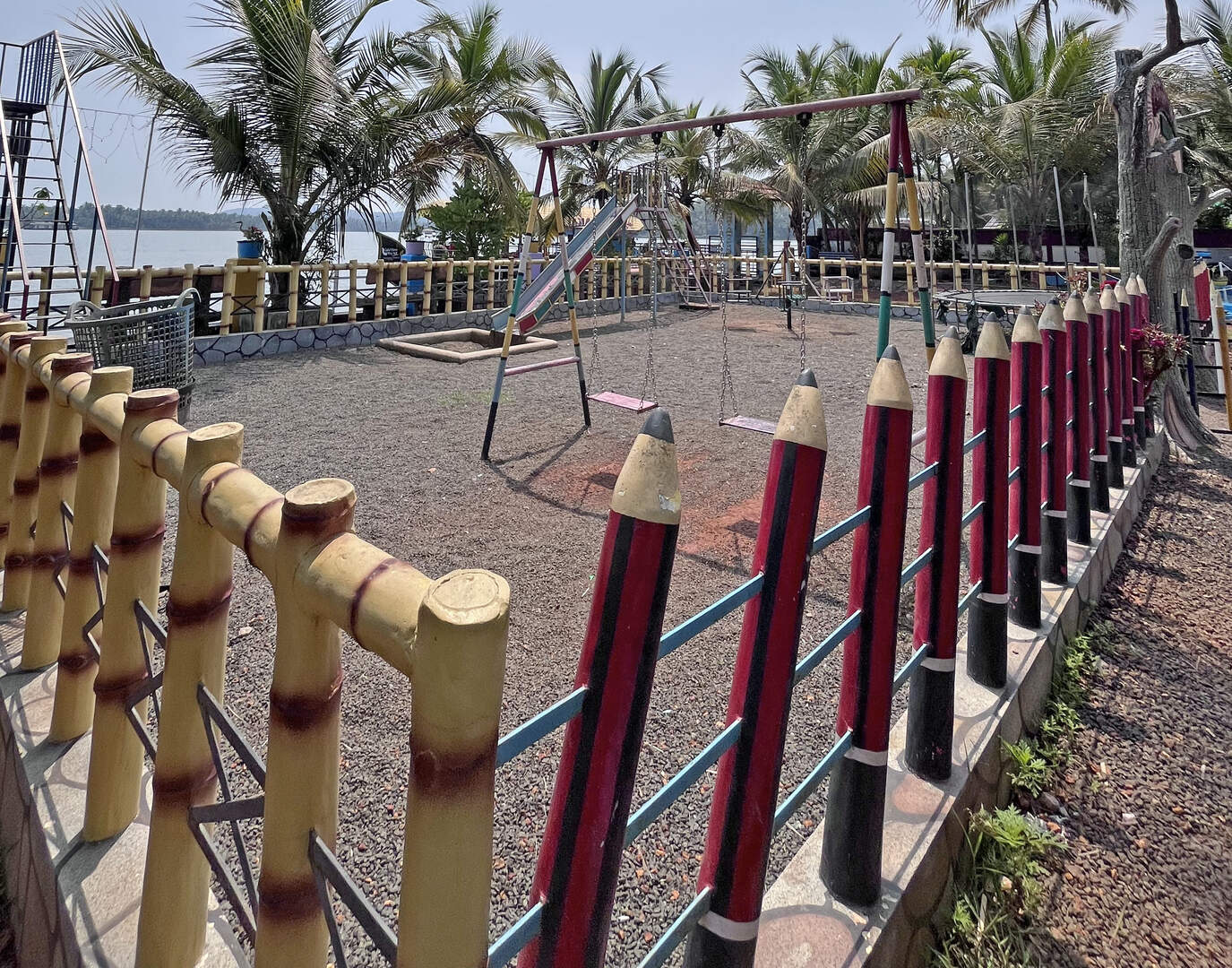 Side view of the park with fencing and palm trees
